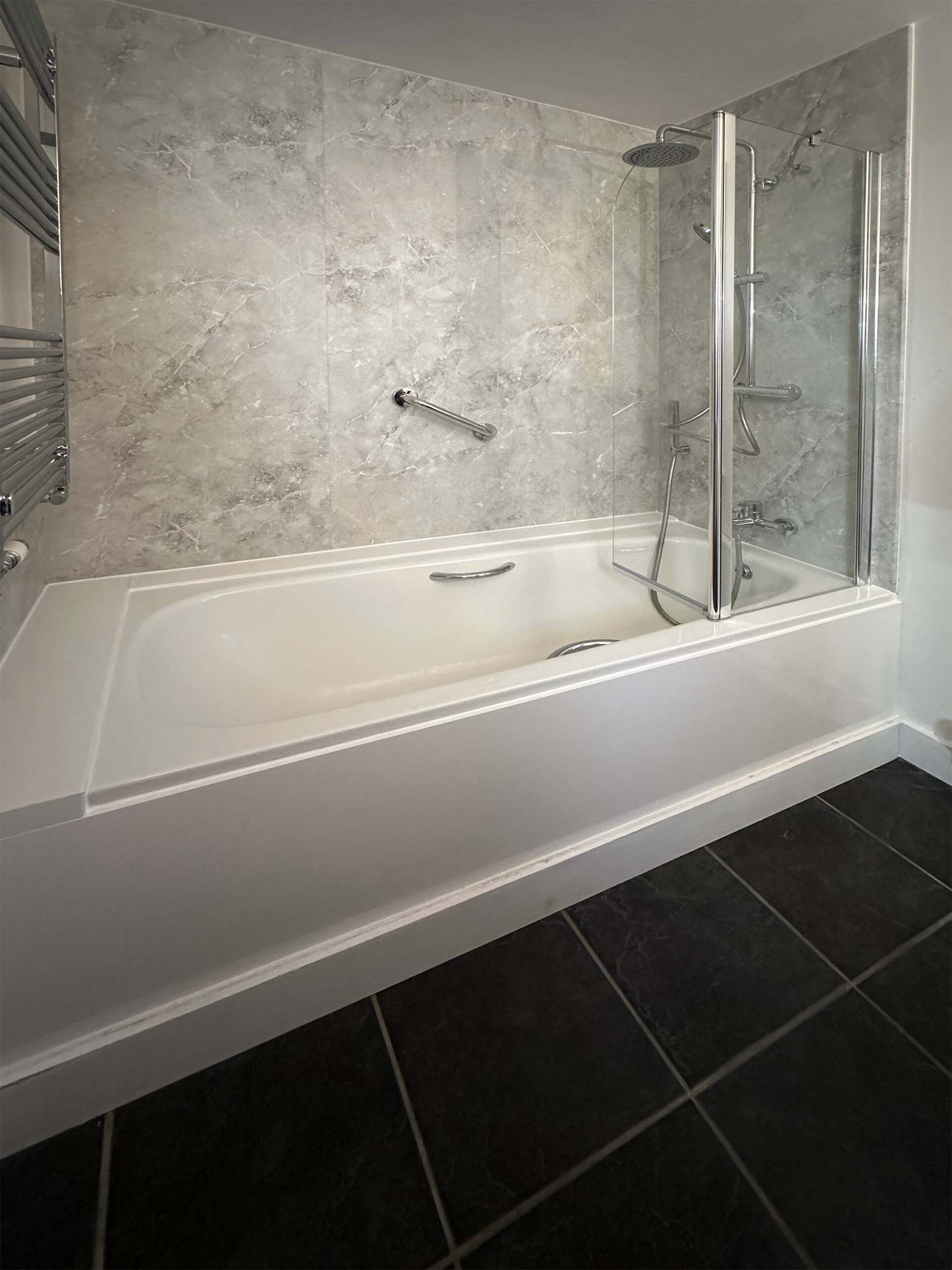 Halton Property Services; Bath with Shower Panel Wall Covering and Grab Handle for Accessibility